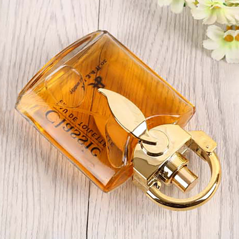 Perfume bottle with gold cap on a wooden surface