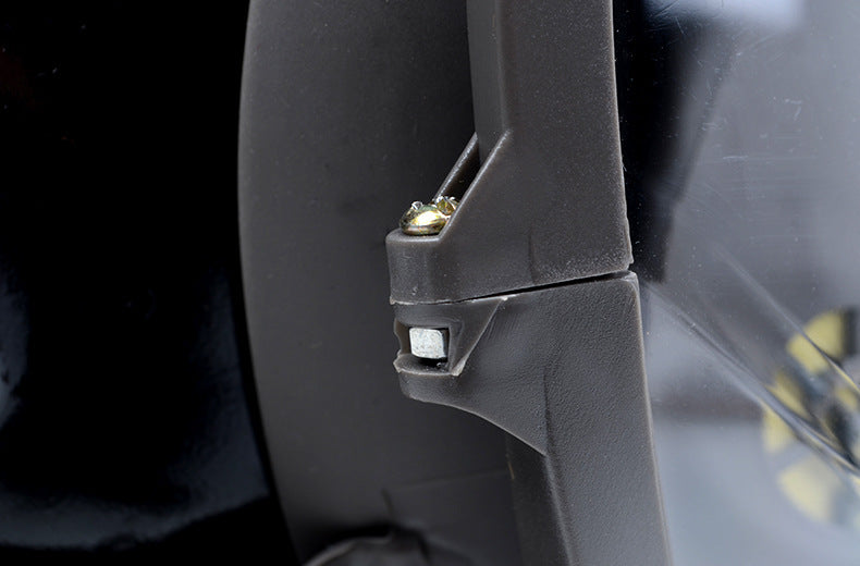 Close-up of a car's side mirror with a black background