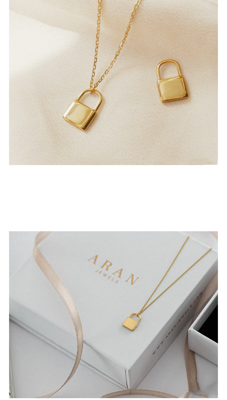 Gold lock-shaped pendant on a beige background with 'ARAN' branding.