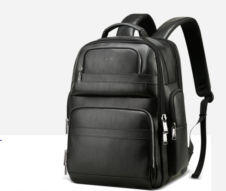 Black backpack with multiple pockets and zippers on a white background