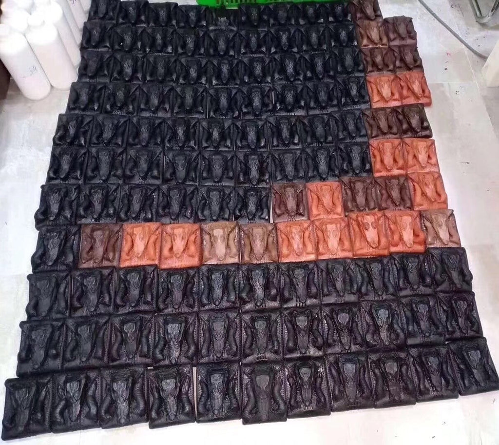 Stack of black and brown plastic trays on a white surface