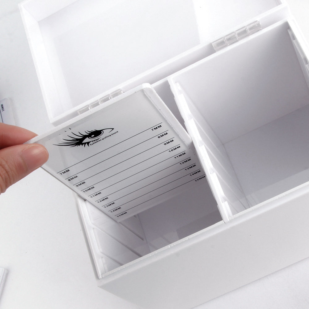 Eyelash extension kit with labeled compartments on a white background