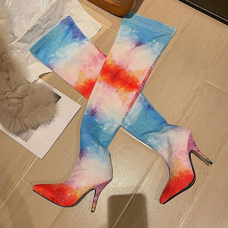 Colorful high-heeled boots on a wooden floor