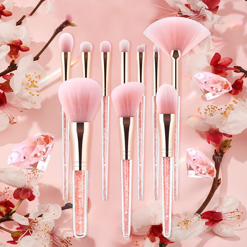 Set of makeup brushes with pink bristles on a floral background
