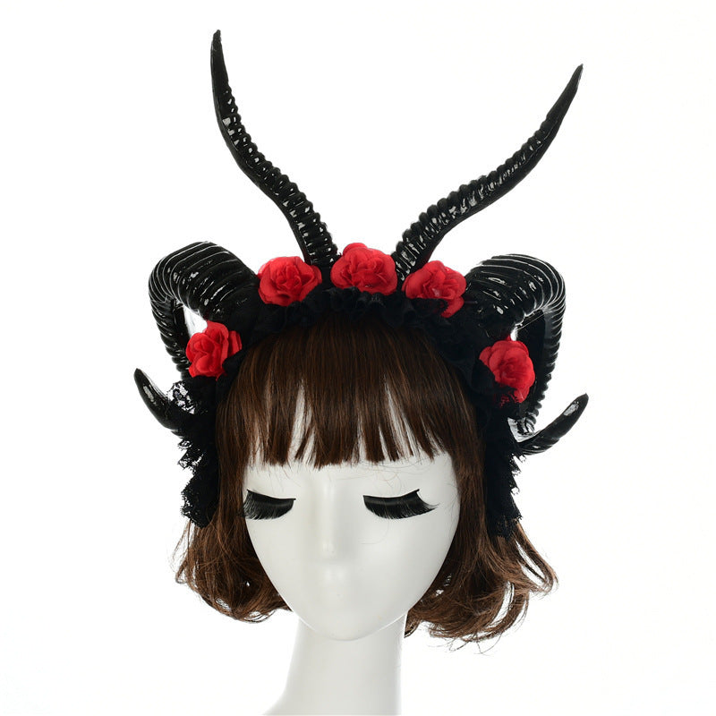 Black horned headpiece with red flowers on a white background