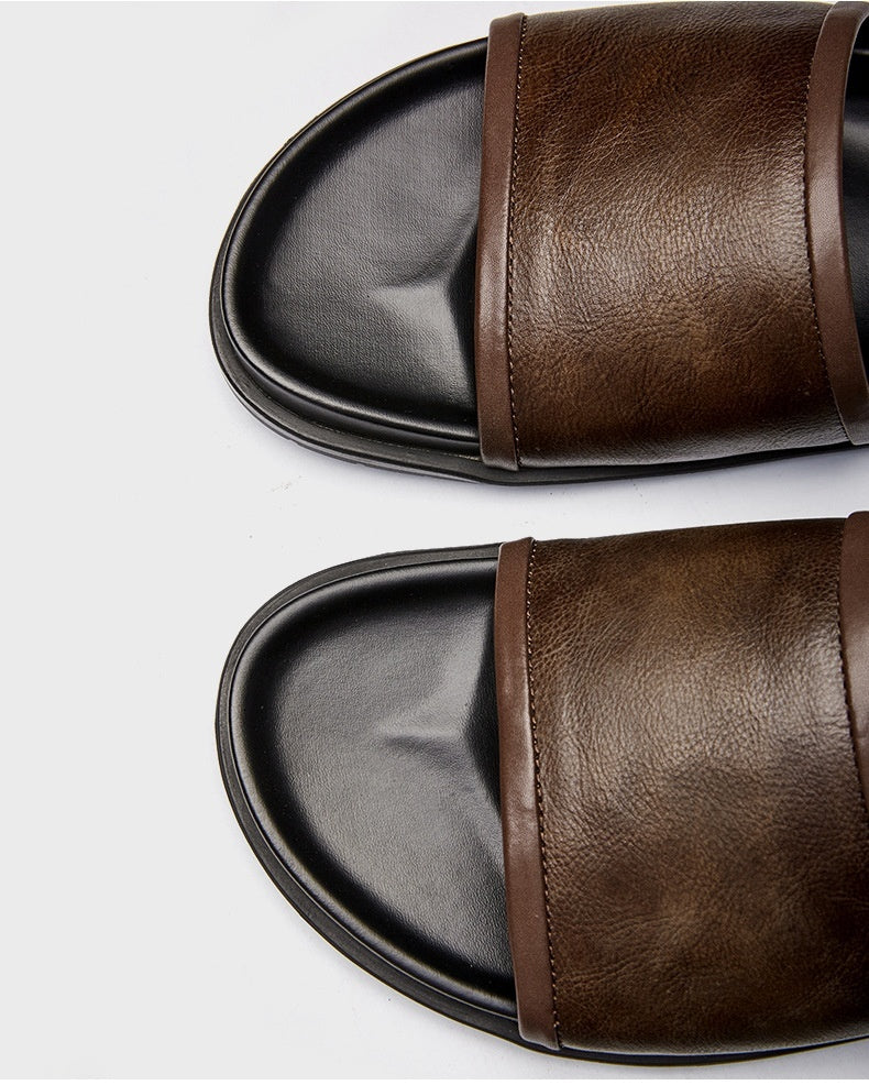 Brown leather slides on a white background