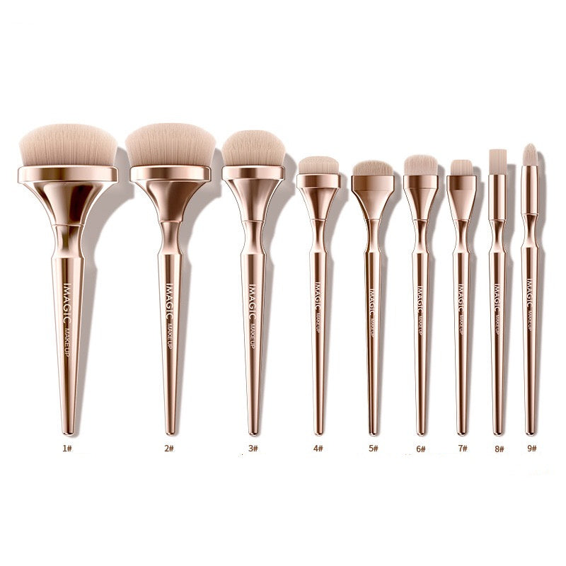 Set of 10 makeup brushes with rose gold handles on a white background