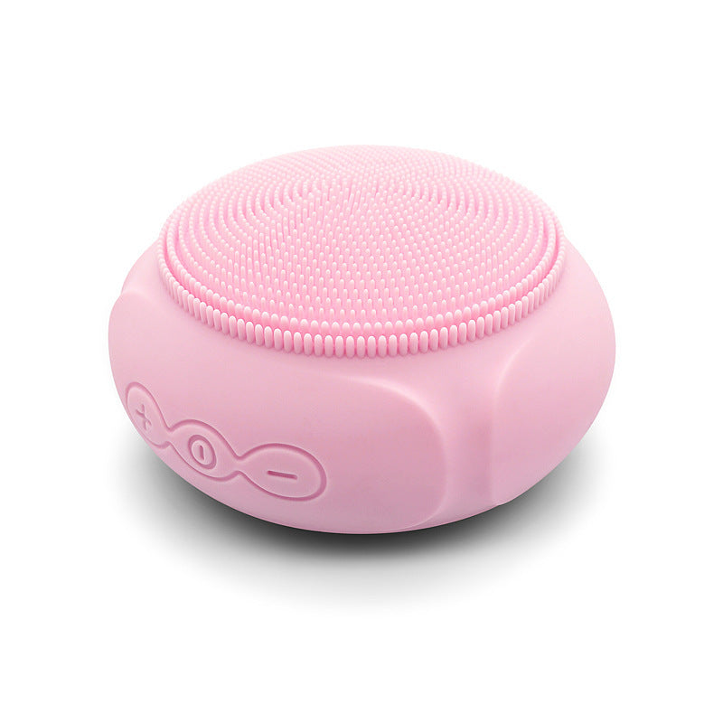Pink silicone scrubber with textured top on a white background