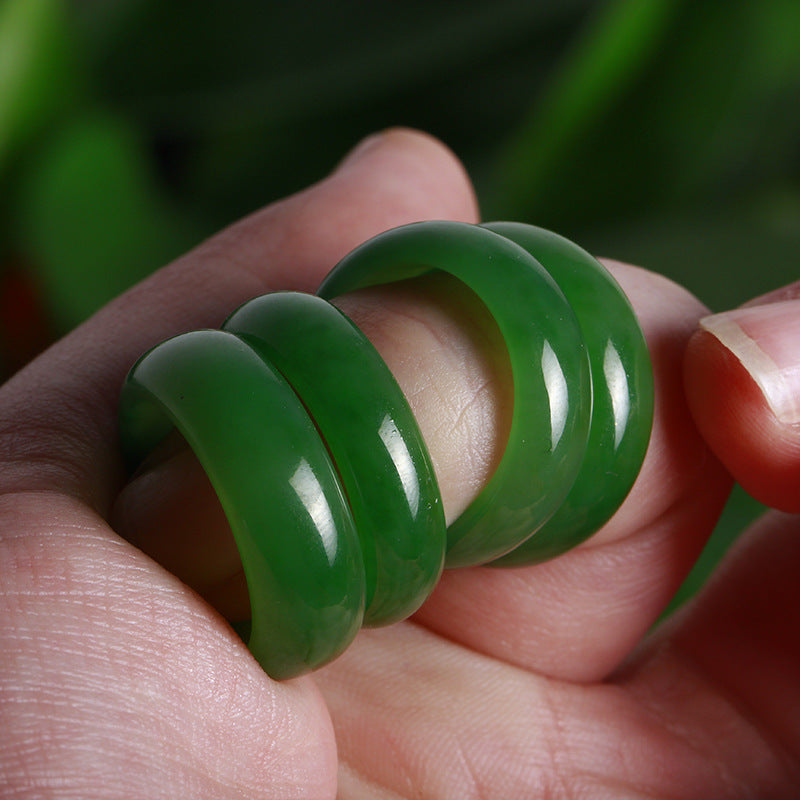 Green spiral object held in a hand with a blurred green background