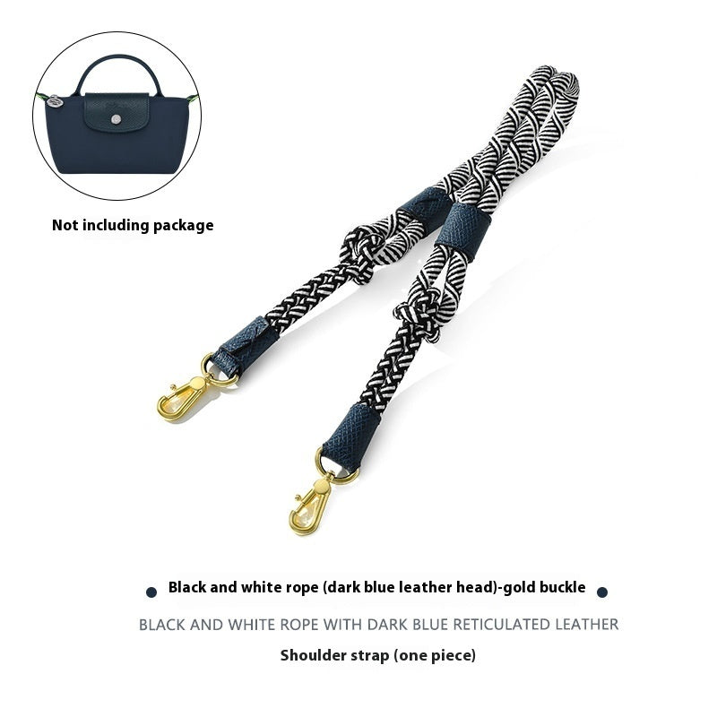 Black and white rope shoulder strap with gold buckle on a white background