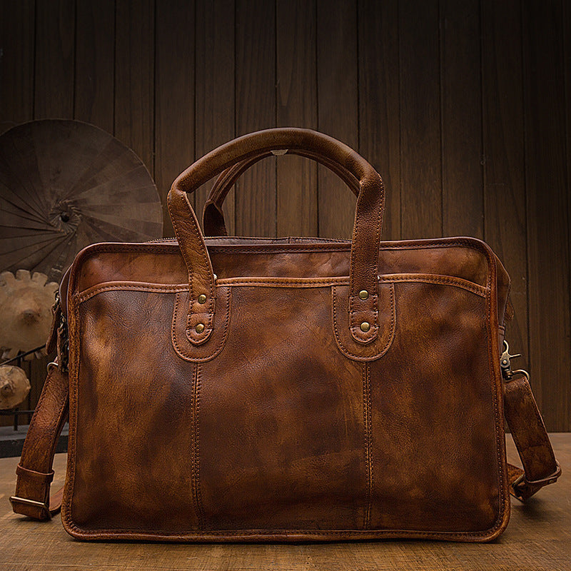 Brown leather briefcase on a wooden surface with a dark wooden background