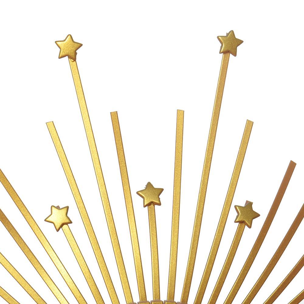 Decorative wall art with gold rays and stars on a white background