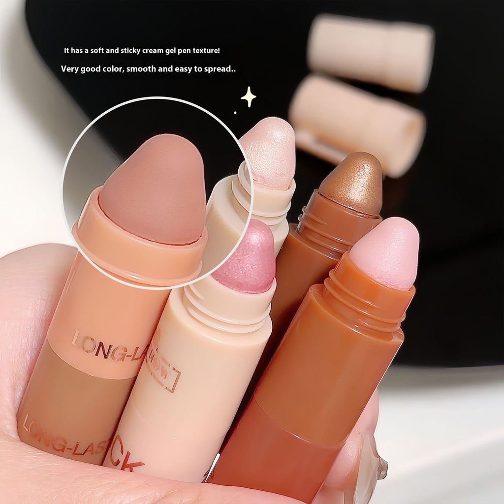 Set of makeup stick applicators with a close-up on texture, held by a hand.