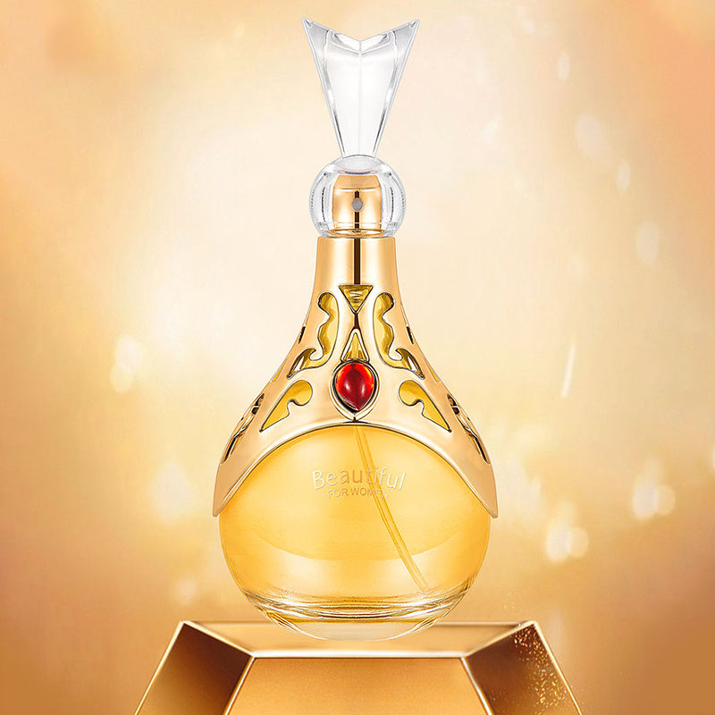 Decorative perfume bottle with gold accents and a red gem on a golden background