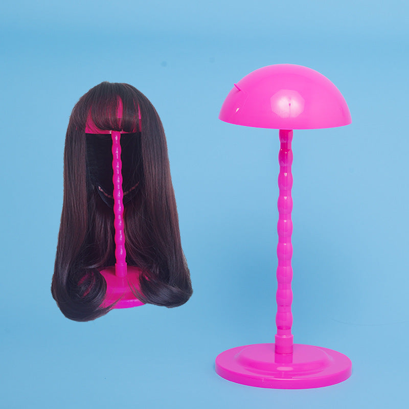 Pink lamp with a wig on a blue background