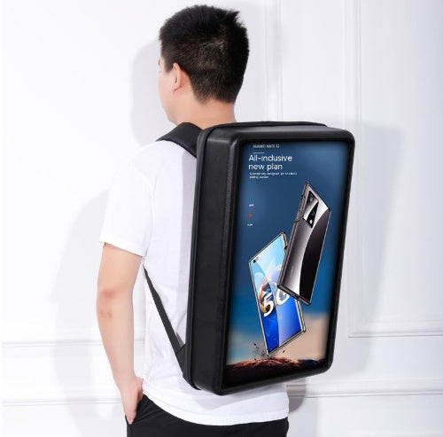 Person wearing a backpack with a digital display showing smartphone images and text.