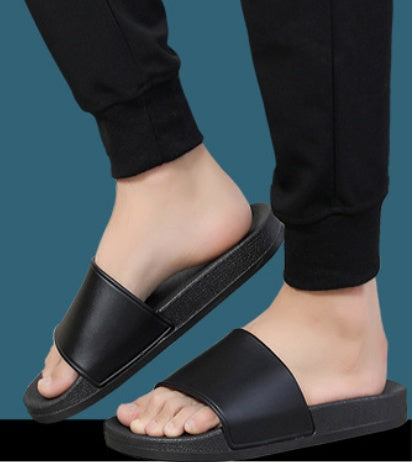 Black sandals worn by a person on a transparent background