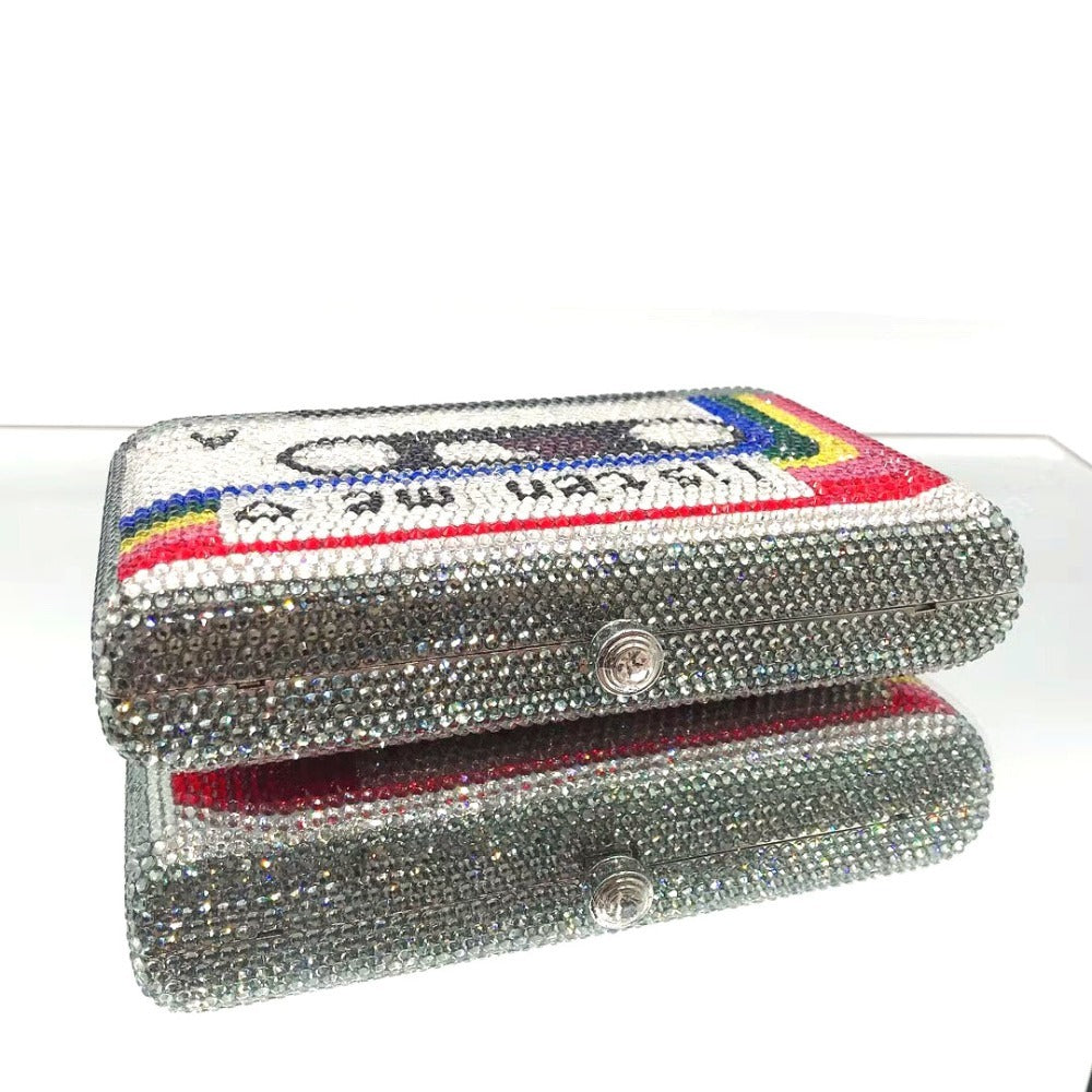 Crystal-embellished clutch with a colorful label on a white background