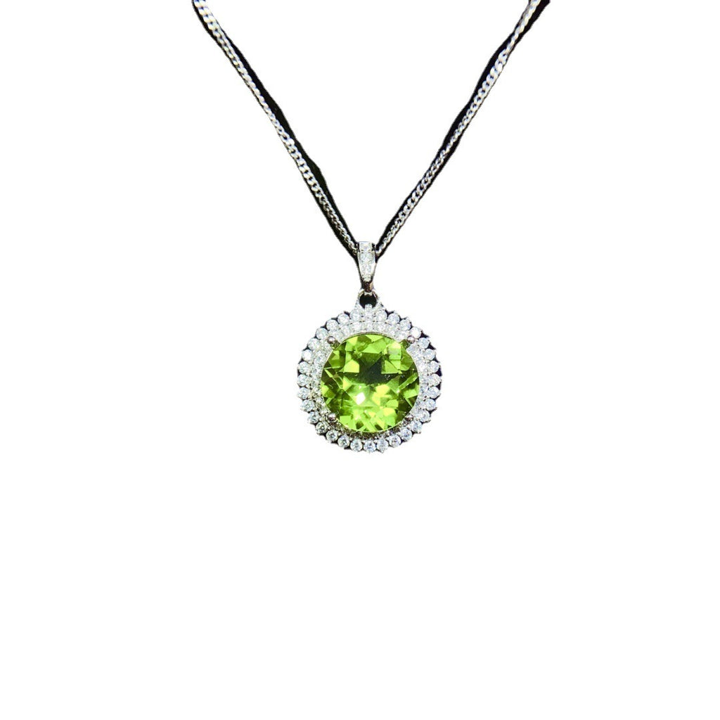 Necklace with a green gemstone pendant on a white background