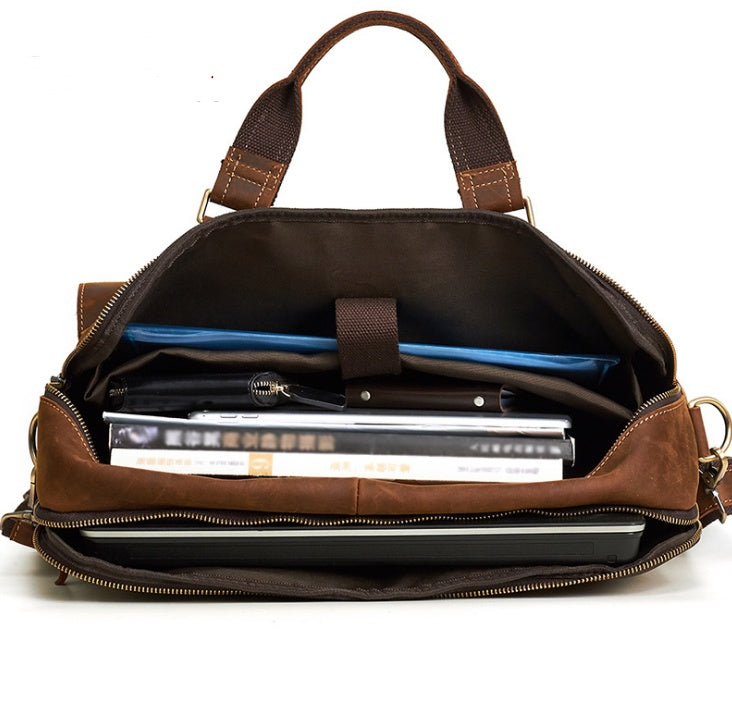 Brown leather briefcase with books and a pen inside on a white background