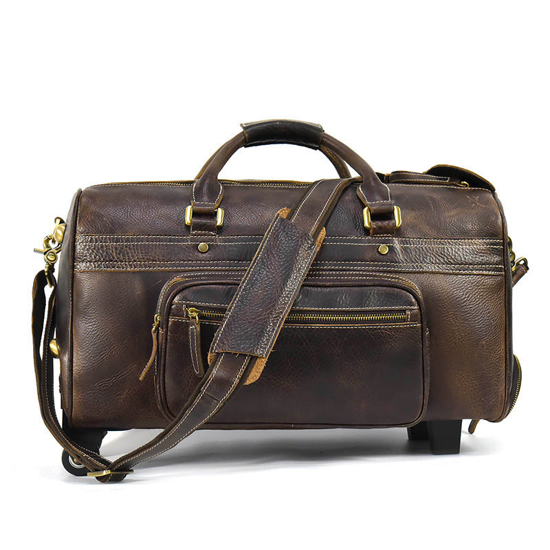 Brown leather duffel bag with gold hardware on a white background