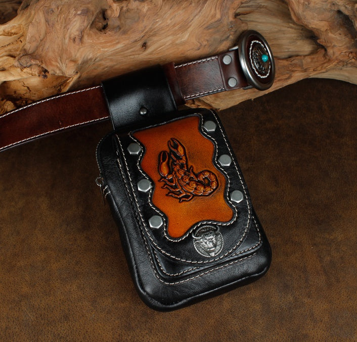 Leather pouch with embossed design on a wooden surface
