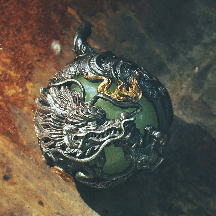 Decorative ring with dragon design on a textured surface