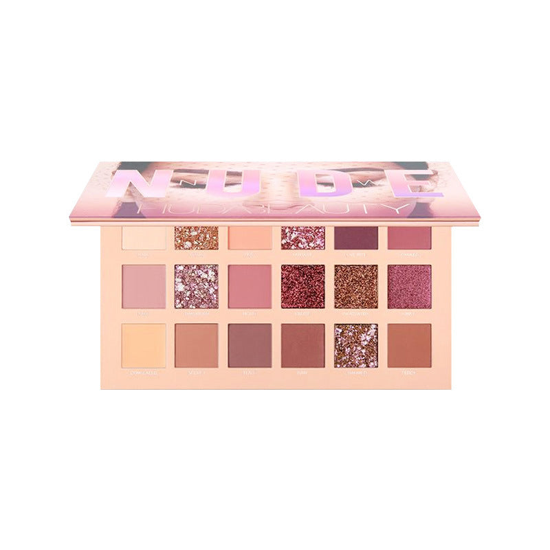 Makeup palette with various shades of pink, purple, and gold on a white background