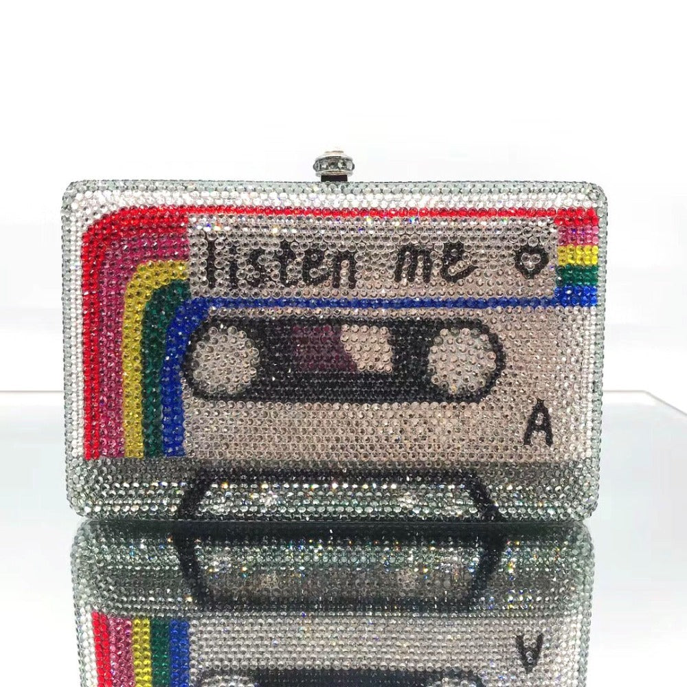 Beaded clutch shaped like a cassette tape with 'listen me' text on a white background