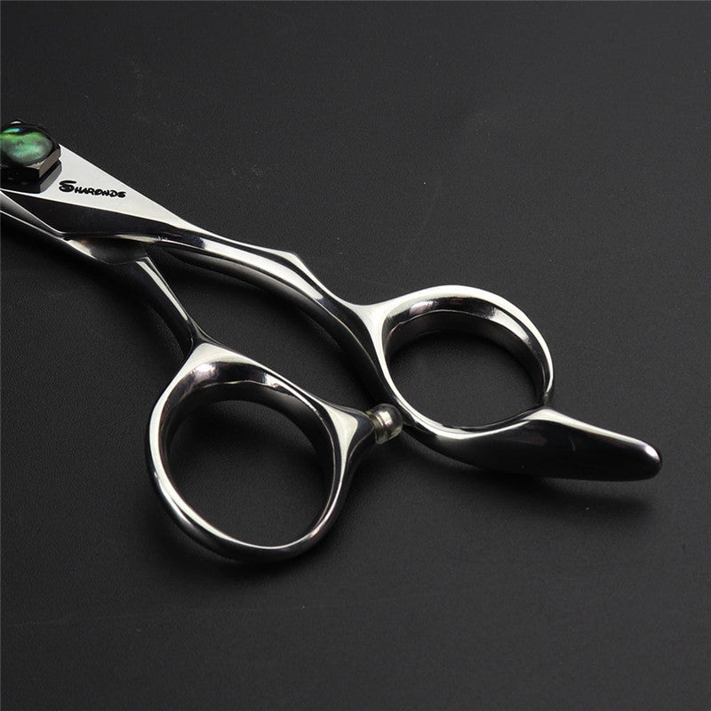 Silver scissors with a dark background