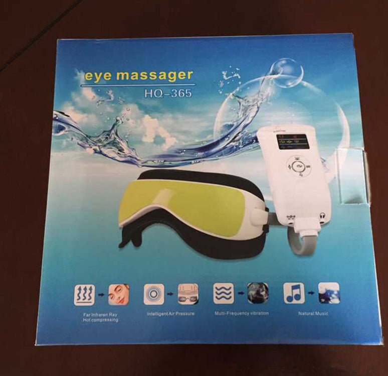 Box of an eye massager with water splash design on a wooden surface