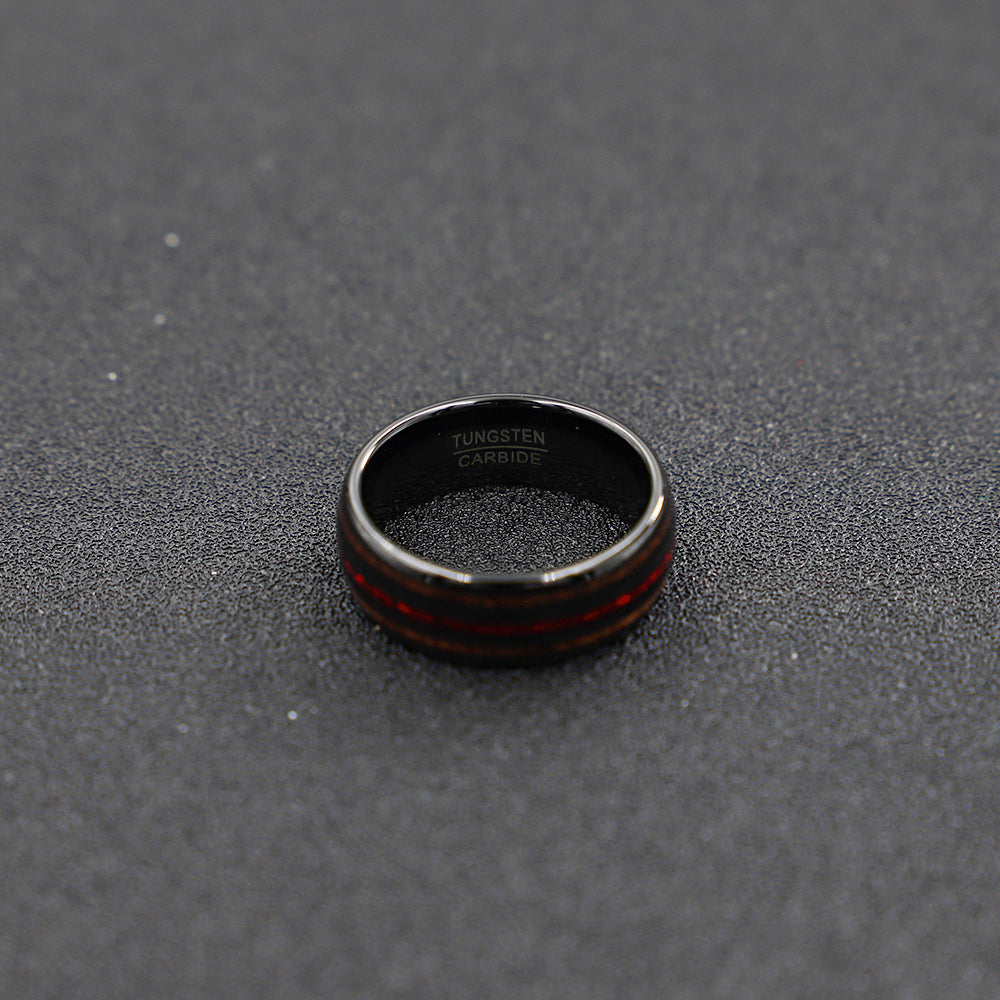 Black ring with red interior on a textured gray surface