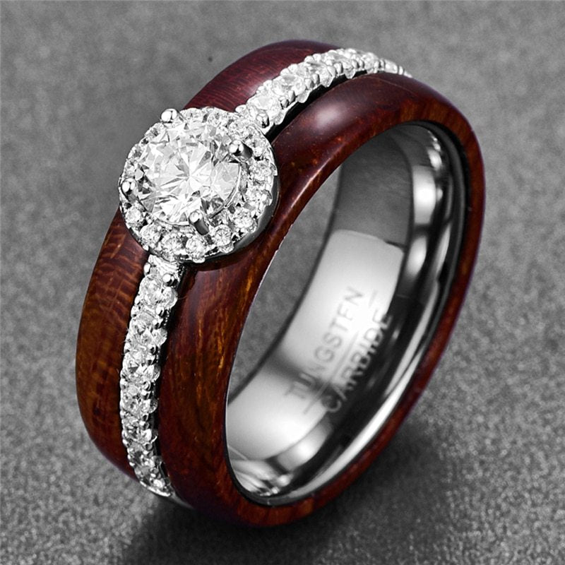 Wooden and metal ring with diamond on a gray background