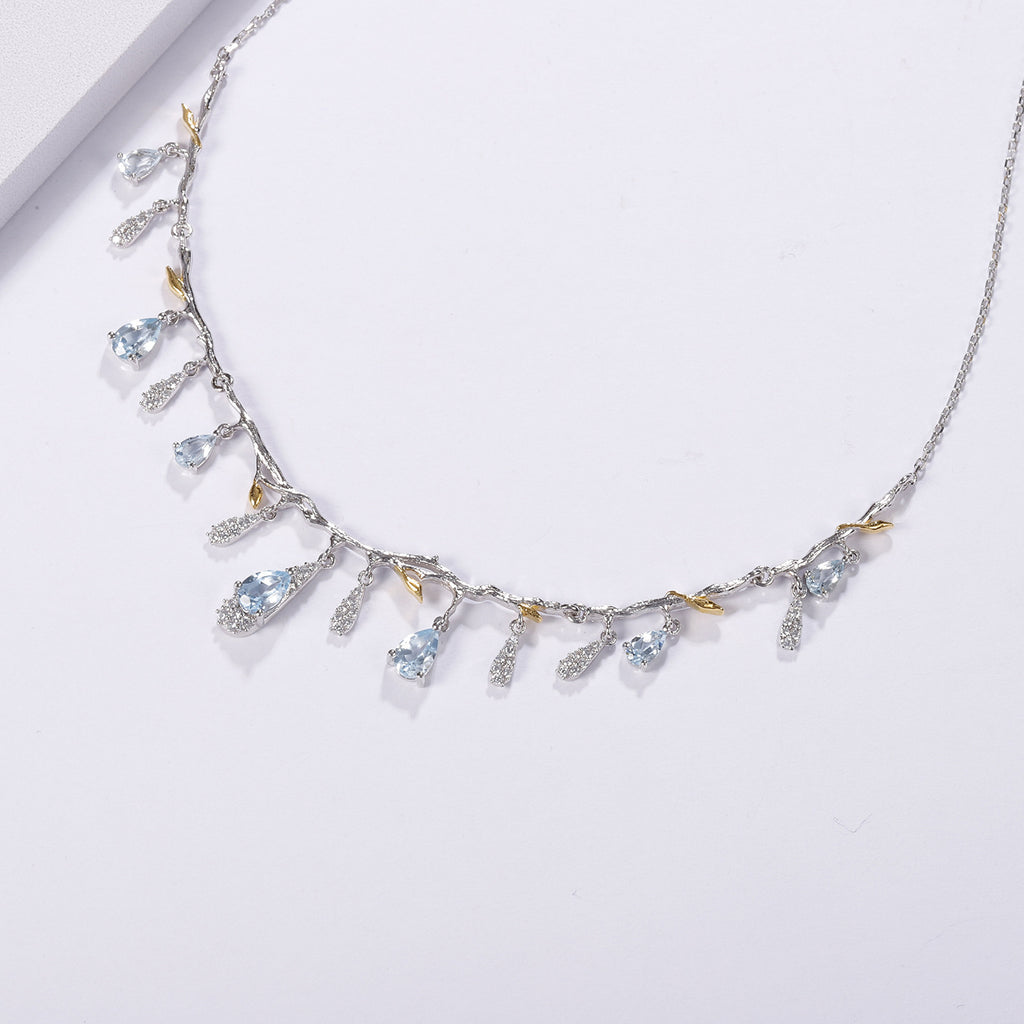 Delicate necklace with gemstones on a light gray background