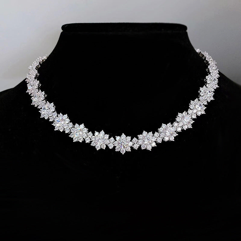 Silver necklace on a black mannequin with a plain background