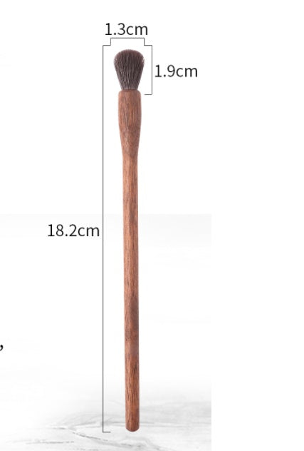 Makeup brush with measurements on a white background