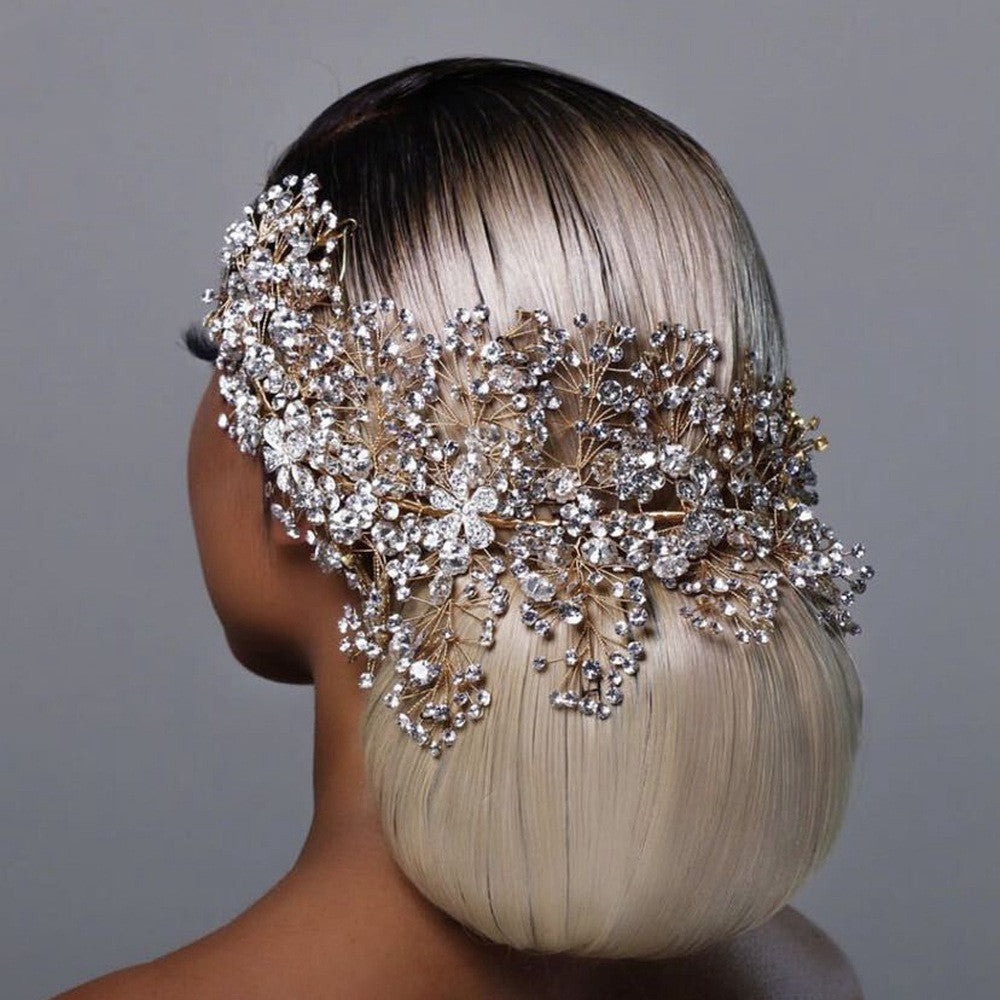 Mannequin head with blonde hair wearing a decorative headpiece against a gray background