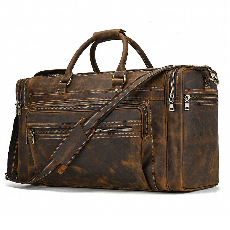Brown leather duffel bag with multiple zippers on a white background