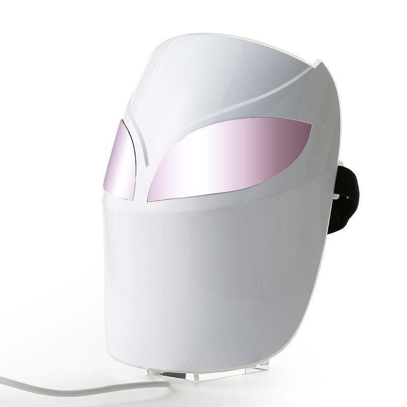 White and pink facial mask device on a white background