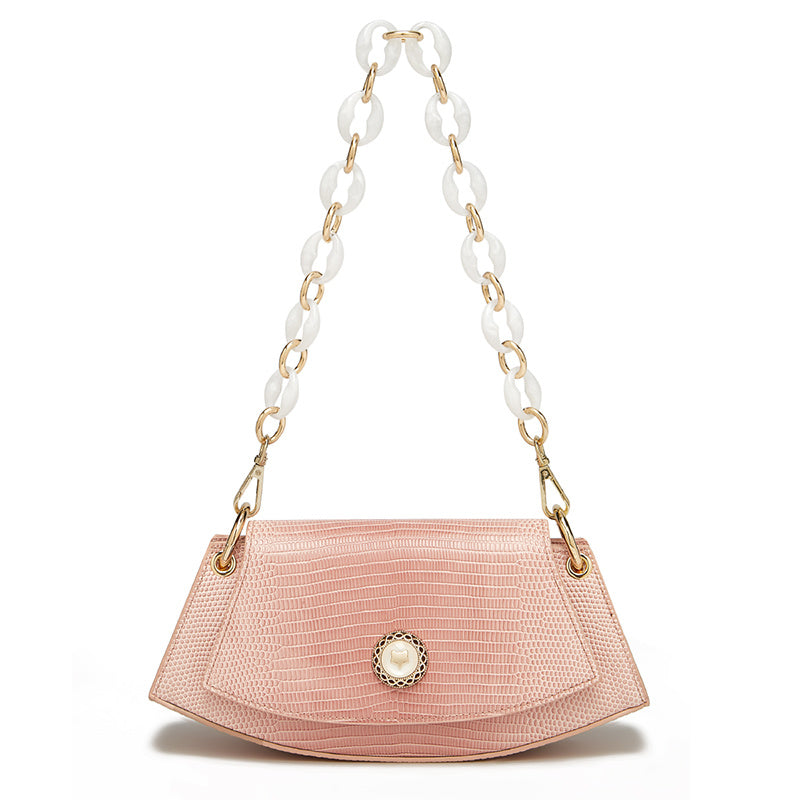 Pink handbag with a white and gold chain strap on a white background
