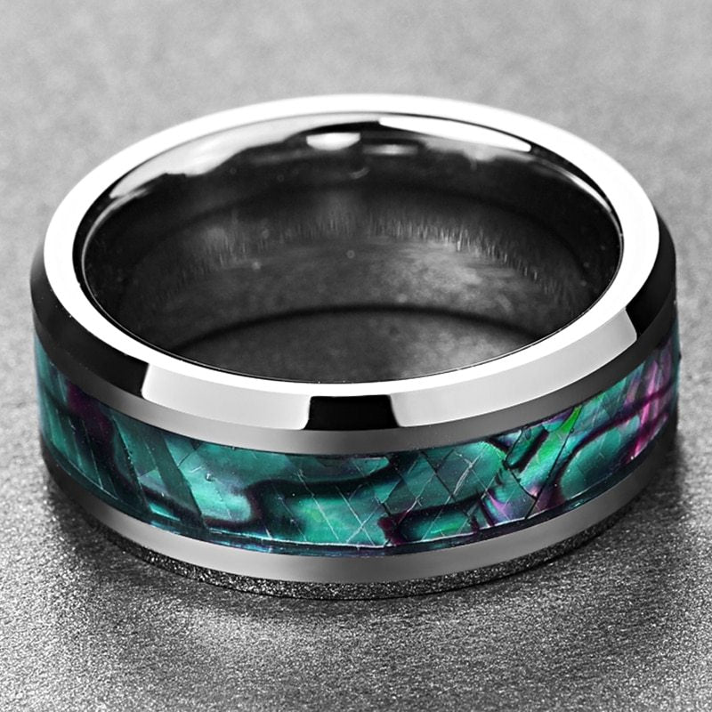 Ring with metallic band and colorful inlay on a gray background