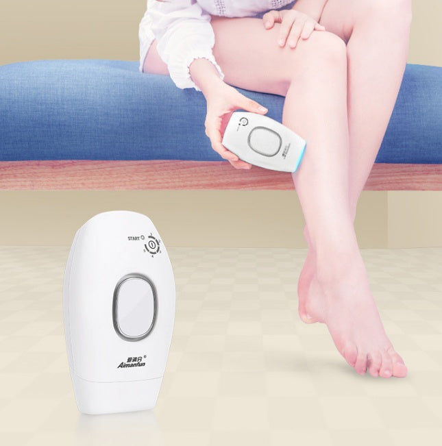 Person using a hair removal device on their leg with a close-up of the device in the foreground.