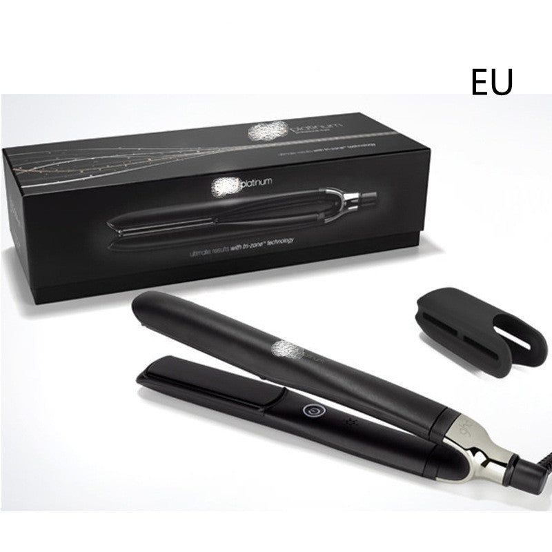 Black hair straightener with packaging and attachments on a white background