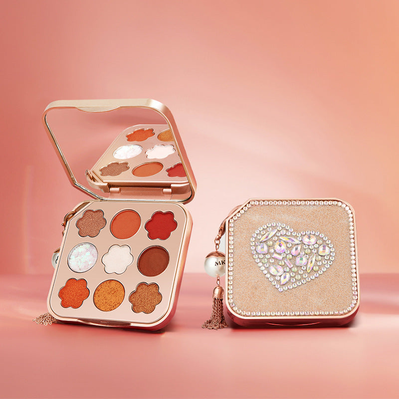 Makeup palette with decorative case on a pink background