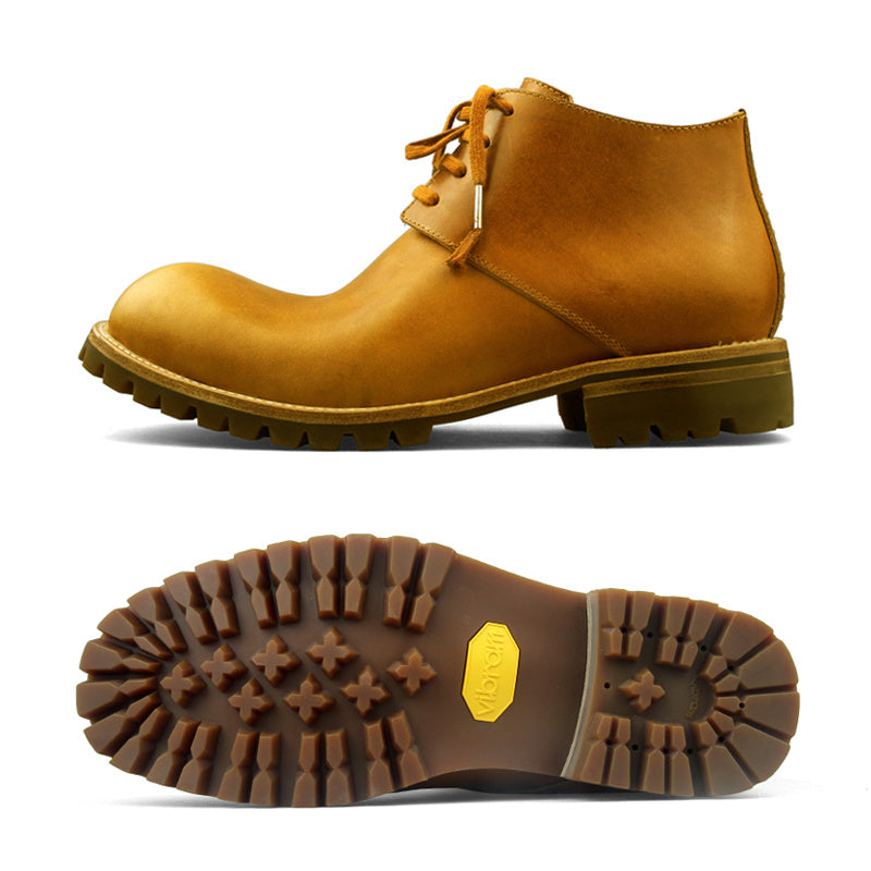 Brown leather boot with a close-up of the sole on a white background