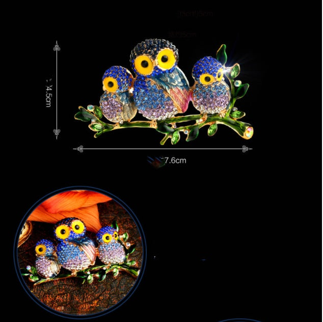 Colorful owl-shaped brooch with crystal details on a branch, shown with measurements and a close-up inset.
