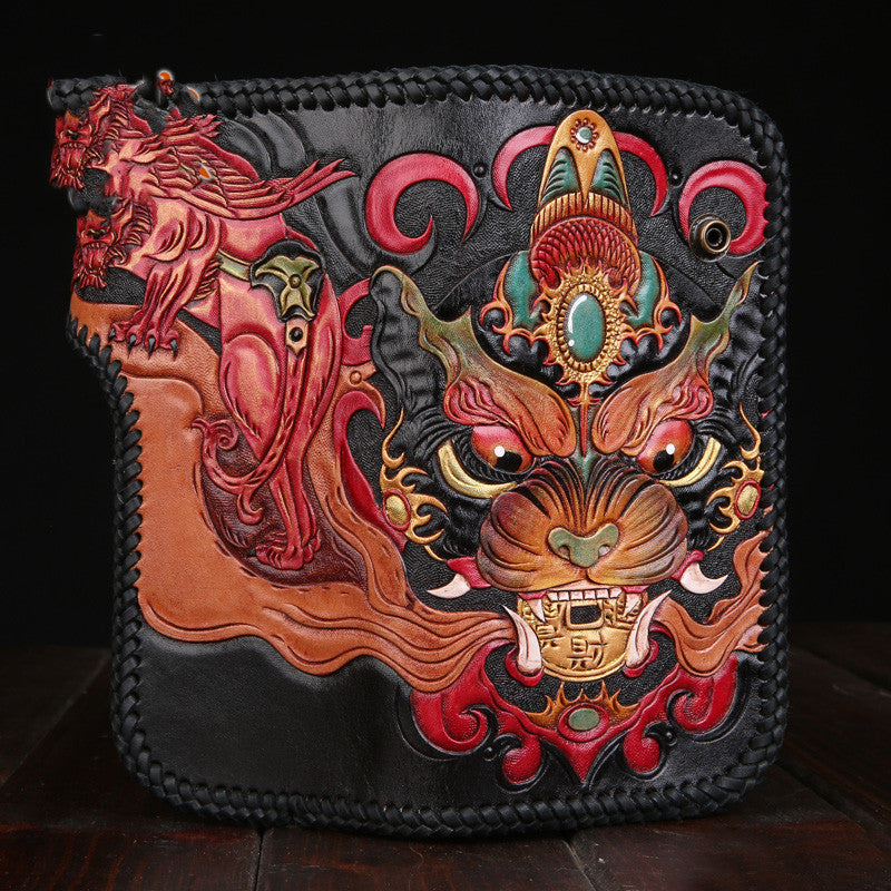 Decorative leather wallet with intricate designs on a dark background