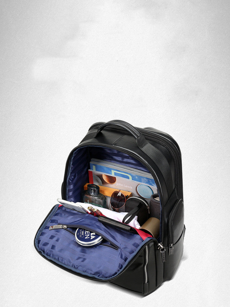 Black backpack with open front compartment showing various items on a white background