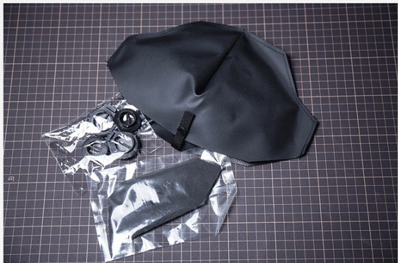 Black fabric item on a grid surface