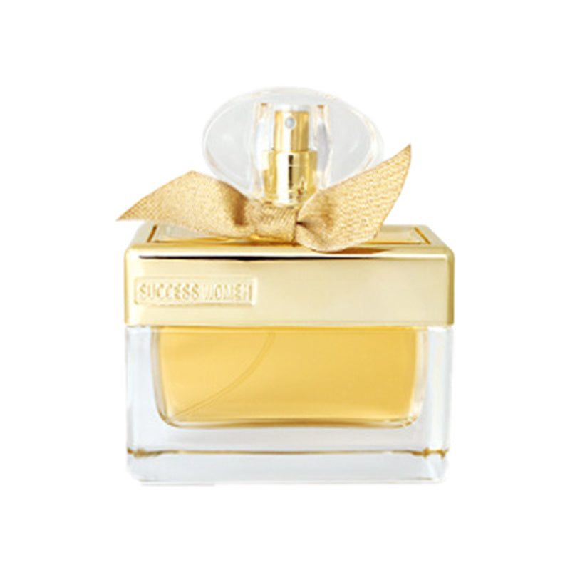 Perfume bottle with gold bow and 'Success Lovers' label on a white background